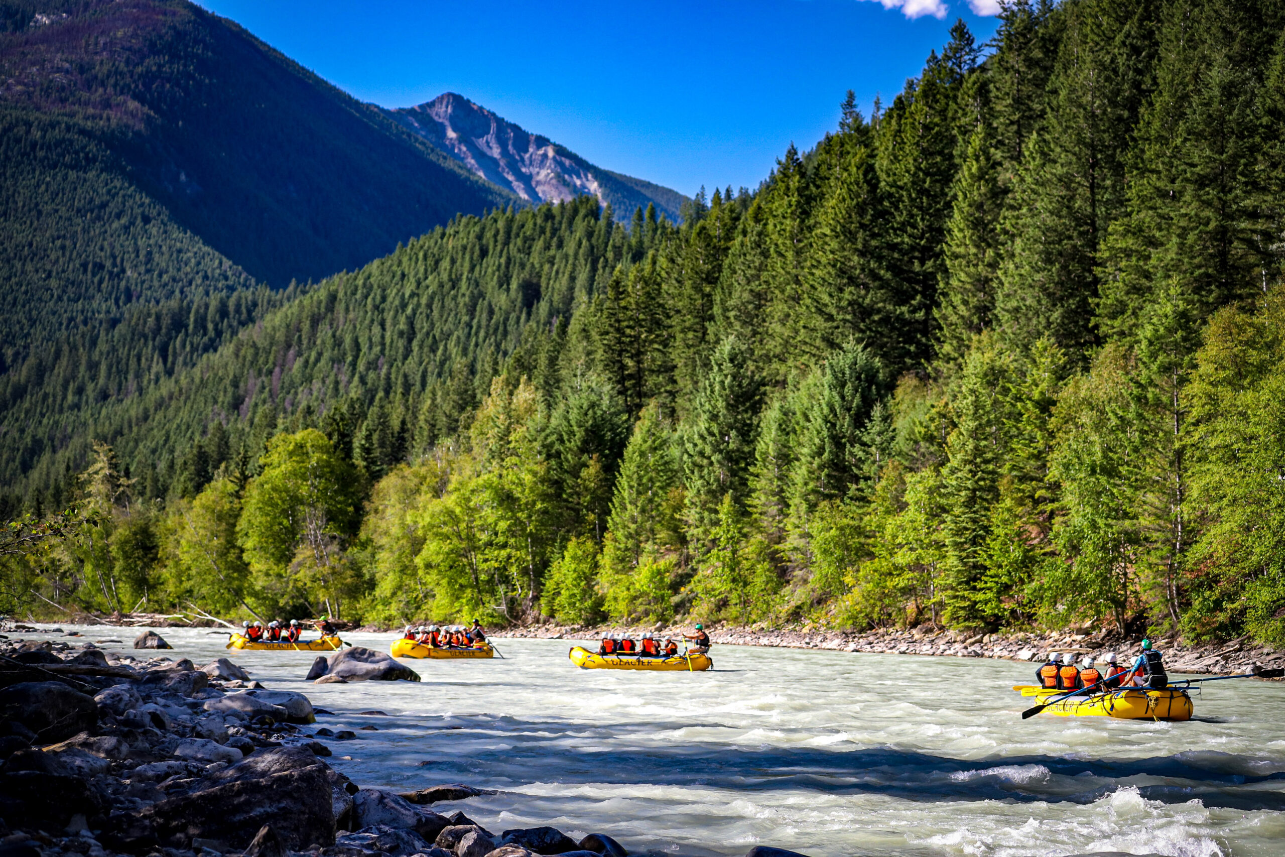 Four groups on rafts navigating on the Kicking Horse River