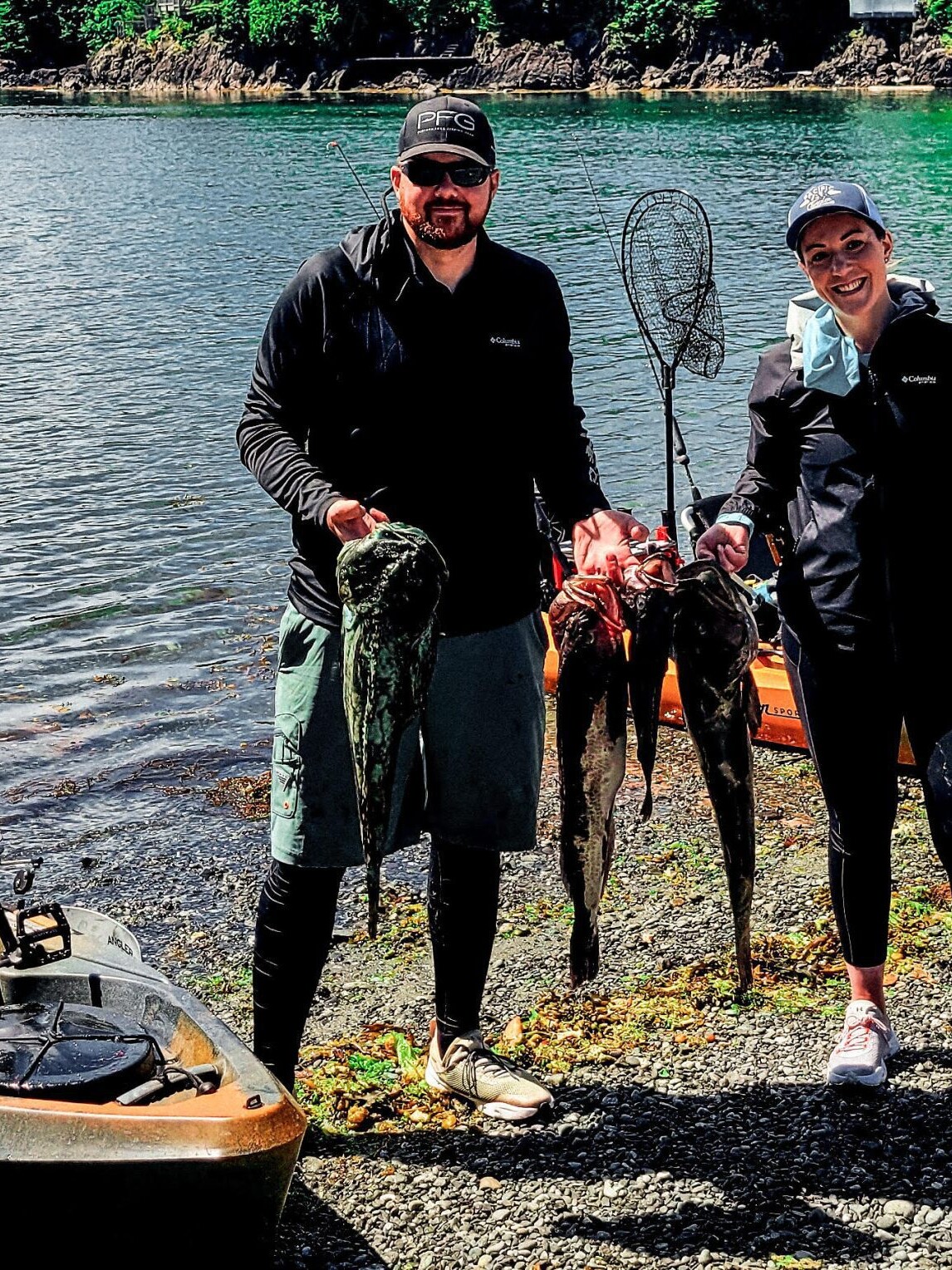 Kayak fishing in BC, people showing caught fish