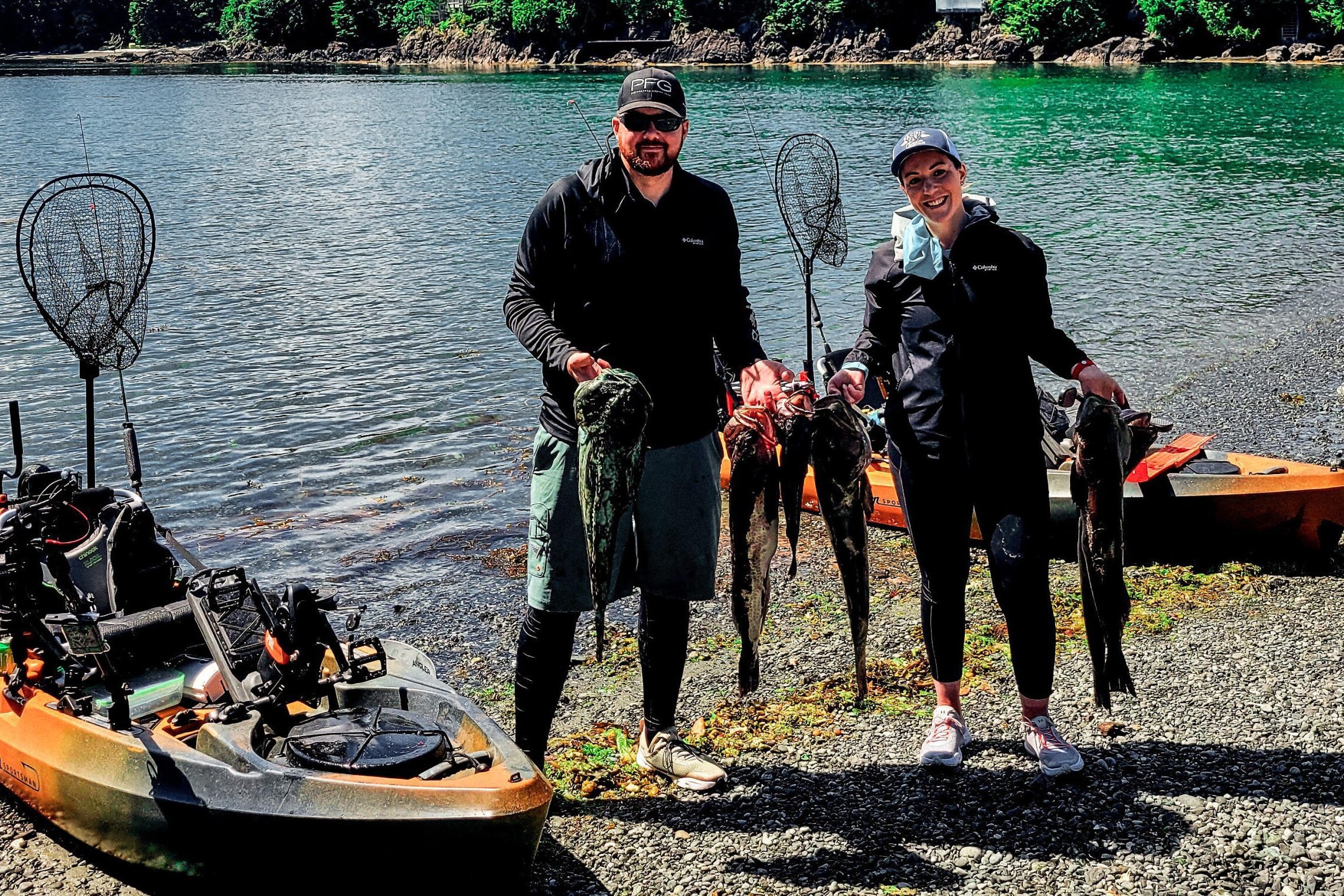 Kayak fishing in BC, people showing caught fish