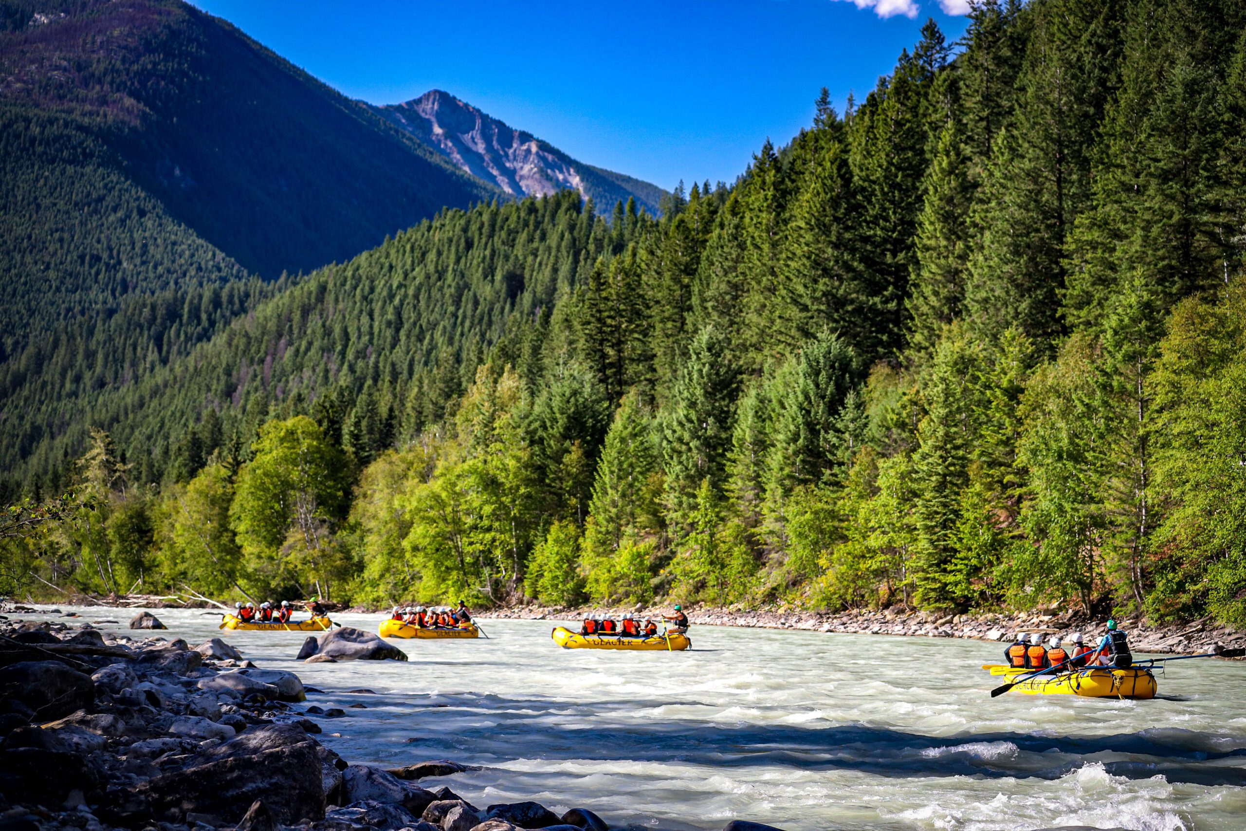 Four groups on rafts navigating on the Kicking Horse River